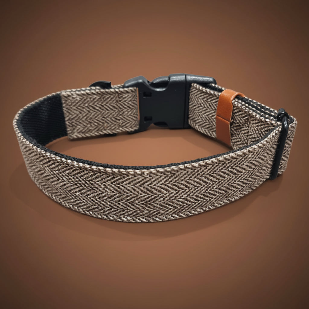 Dog collar with herringbone pattern and brown leather strap on a brown background