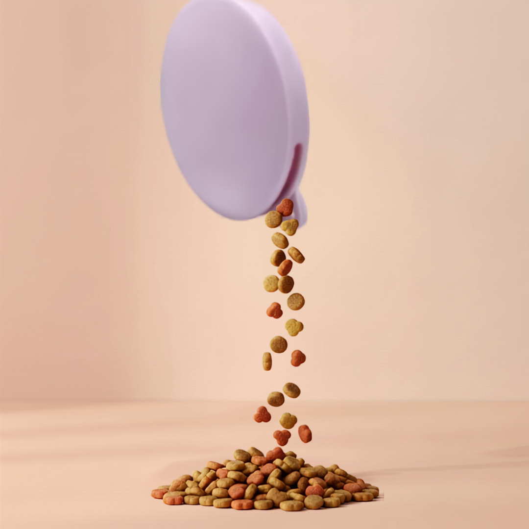pink dog treat pouch with dog kibble falling out