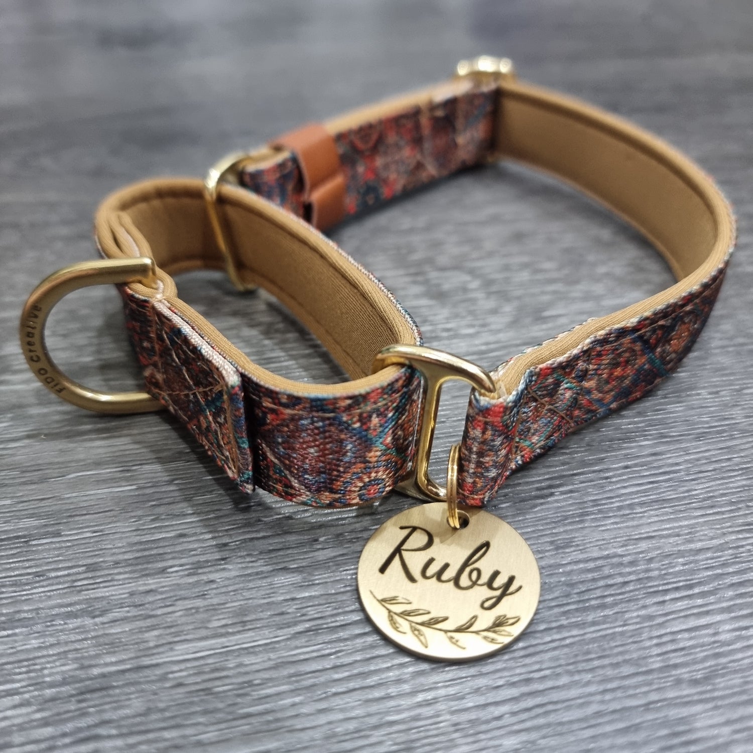 Patterned dog collar with a gold tag 